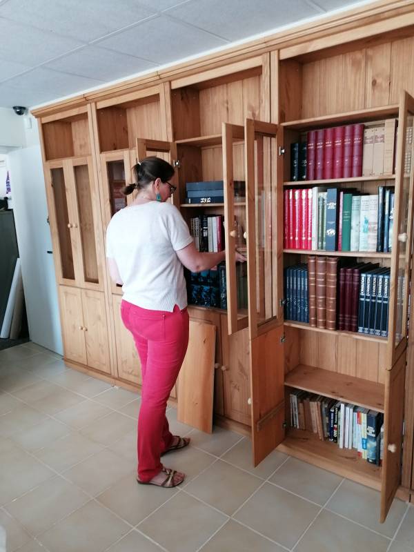 Our librarian organizing the bookshelves