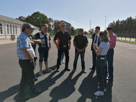 The owners of the vehicles listen to the journalist's instructions