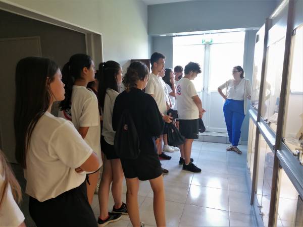 Marie presenting the display cases in the corridor to her group