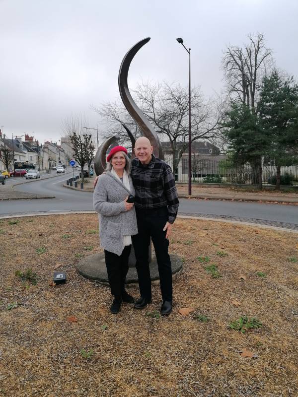 Betty and George in front of the flame of remembrance offered by an anonymous American