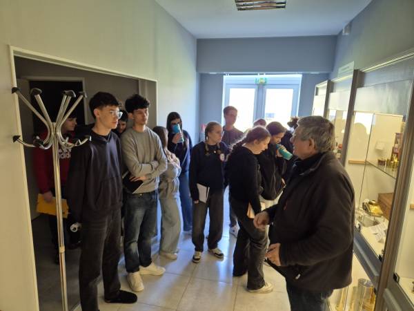 Dominique explains the contents of the display cases to his group